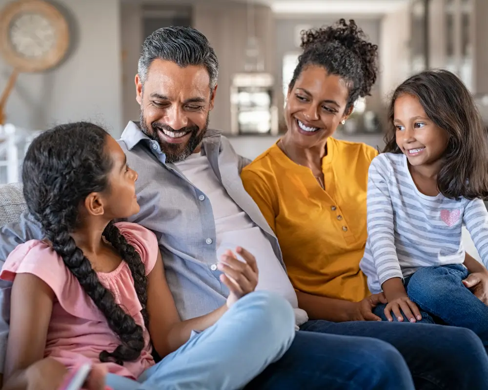 family sitting on a sofa